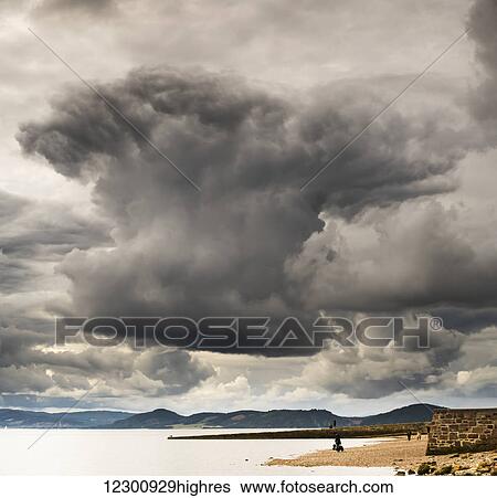 Stock Photograph - Dramatic cloud formation over the coastline, Chanonry Point; Inverness, Scotland. Fotosearch