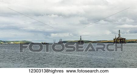 Drilling rigs off the coast with farmland in the background; Invergorden, Scotland View Large Photo Image Stock Photograph - Drilling rigs off the coast with farmland in the background; Invergorden, Scotland. Fotosearch