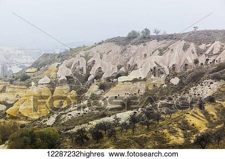 Stock Photograph - Dwellings and fairy chimneys: Goreme, Cappadocia, Turkey. Fotosearch