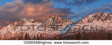 Stock Photograph - Evening light on Twin Peaks and Pioneer Peak of the Chugach Mountain Range, Southcentral Alaska, spring.. Fotosearch