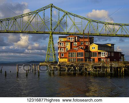 Stock Photograph - Evening light warms the Astoria-Megler Bridge; Astoria, Oregon, United States of America. Fotosearch