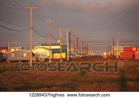 Stock Photograph - Evening sunset view of houses in Barrow, North Slope, Arctic Alaska, Summer. Fotosearch