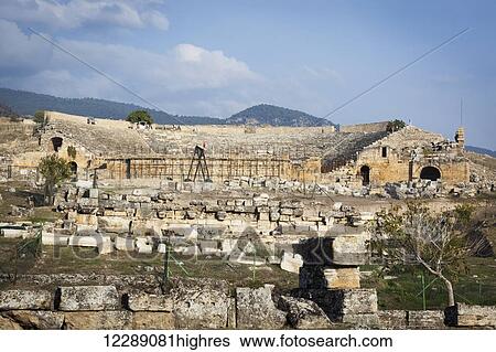 Stock Photograph - Excavation of the ruins of an ancient Greco-Roman theatre; Pamukkale, Turkey. Fotosearch