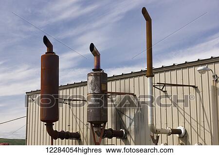Stock Photograph - Exhaust vents on the outside of a large electrical power plant, Sand Point, Southwestern Alaska, USA, Summer. Fotosearch