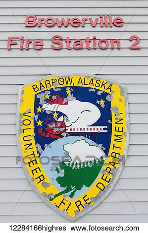 Stock Photograph - Exterior view of the badge and lettering on the wall of the Browerville Fire Station, Barrow, North Slope, Arctic Alaska, USA, Winter. Fotosearch