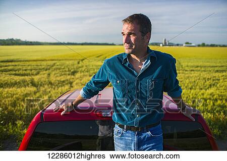 Farmer standing in back of pickup truck looking at barley field; Bradford, Ontario, Canada View Large Photo Image Stock Photograph - Farmer standing in back of pickup truck looking at barley field; Bradford, Ontario, Canada. Fotosearch
