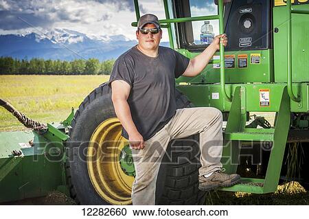Farmer standing in front of his self propelled disc mower; Delta Junction, Alaska, United States of America View Large Photo Image Stock Image - Farmer standing in front of his self propelled disc mower; Delta Junction, Alaska, United States of America. Fotosearch
