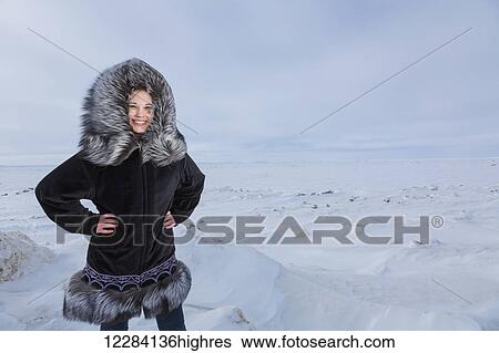 Female native youth wearing a traditional fur parka while standing on ice along the Arctic Ocean, Barrow, North Slope, Arctic Alaska, USA, Winter View Large Photo Image Stock Photograph - Female native youth wearing a traditional fur parka while standing on ice along the Arctic Ocean, Barrow, North Slope, Arctic Alaska, USA, Winter. Fotosearch