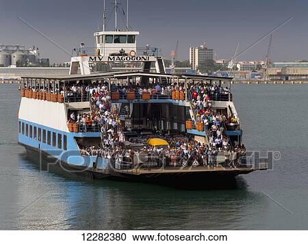 Ferry crossing the water full of passengers; Dar es Salaam, Tanzania View Large Photo Image Stock Image - Ferry crossing the water full of passengers; Dar es Salaam, Tanzania. Fotosearch