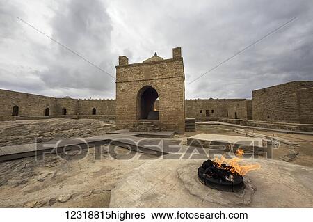 Stock Photograph - Fire in a place of sacrifice in the courtyard of the Ateshgah Temple or Fire Temple of Baku, a Hindu and Zoroastrian place of worship; Surakhani, Baku, Azerbaijan. Fotosearch