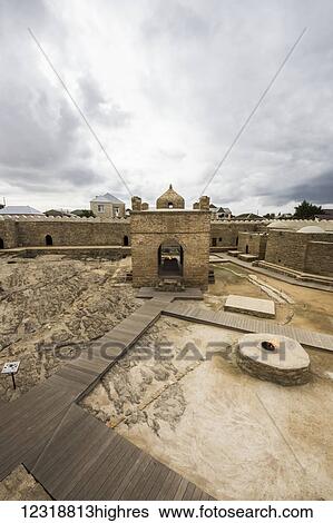 Stock Photograph - Fire in the courtyard of the Ateshgah Temple or Fire Temple of Baku, a Hindu and Zoroastrian place of worship; Surakhani, Baku, Azerbaijan. Fotosearch