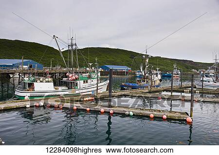 Stock Photograph - Fishing boats docked in the Sand Point Harbor, Sand Point, Southwestern Alaska, USA, Summer. Fotosearch