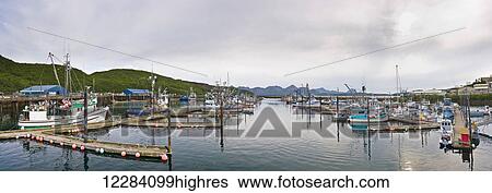 Stock Photograph - Fishing boats docked in the Sand Point Harbor, Sand Point, Southwestern Alaska, USA, Summer. Fotosearch