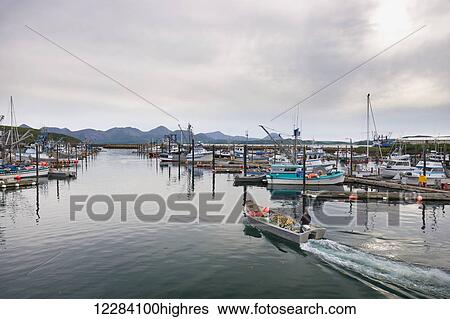 Stock Photograph - Fishing boats docked in the Sand Point Harbor, Sand Point, Southwestern Alaska, USA, Summer. Fotosearch