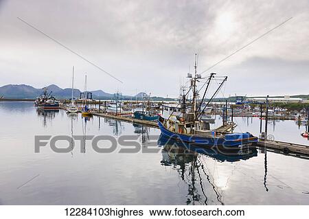 Stock Photograph - Fishing boats docked in the Sand Point Harbor, Sand Point, Southwestern Alaska, USA, Summer. Fotosearch