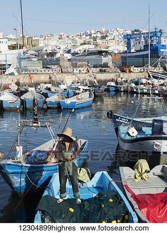 Fishing boats in the port with whitewash buildings on the hillside; Tangier, Morocco View Large Photo Image Stock Photograph - Fishing boats in the port with whitewash buildings on the hillside; Tangier, Morocco. Fotosearch