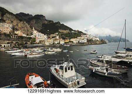 Stock Photograph - Fishing boats mooring in the harbour along the Amalfi coast; Amalfi, Campania, Italy. Fotosearch