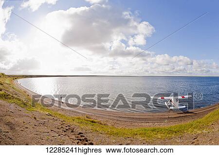 Stock Photograph - Floatplane on beach in Egigik, Alaska Peninsula, Southwest Alaska, summer. Fotosearch
