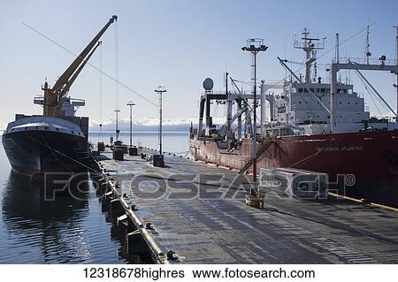 Stock Photograph - Freighters unload at dock; Ushuaia, Magallanes and Antartica Chilena, Argentina. Fotosearch