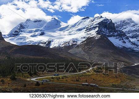 Stock Photograph - Fuel truck and tour buses by Columbia Icefields with Mount Athabasca; Alberta, Canada. Fotosearch