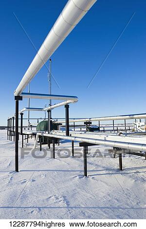 Stock Photograph - Gas pipelines in the winter snow; Morinville, Alberta, Canada. Fotosearch