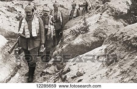 German soldiers wearing spiked helmets and carrying ammunition cartridges around their necks walk along a trench during World War One. From The Pageant of the Century, published 1934 View Large Photo Image Stock Photo - German soldiers wearing spiked helmets and carrying ammunition cartridges around their necks walk along a trench during World War One. From The Pageant of the Century, published 1934. Fotosearch