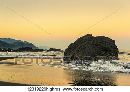 Stock Photograph - Golden sunset over Waiao beach in Yilan Country, beautiful volcanic landscape; Taiwan, China. Fotosearch