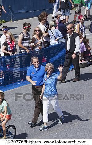 Stock Photograph - Governor Sean Parnell and his wife Sandy lead a group of Parnell supporters in a parade preceeding the annual Mt. Marathon race. 4th of July, 2014 in Seward, Southcentral Alaska. Summer.. Fotosearch