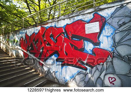 Stock Photograph - Graffiti in a pedestrian tunnel; Trier, Germany. Fotosearch