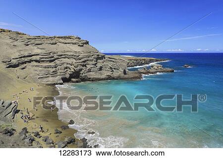 Stock Image - Green Sand Beach, or Papakolea Beach, is a hike from South Point Hawaii and is know for the distinct color from olivine mineral; Naalehu, Island of Hawaii, Hawaii, United States of America. Fotosearch