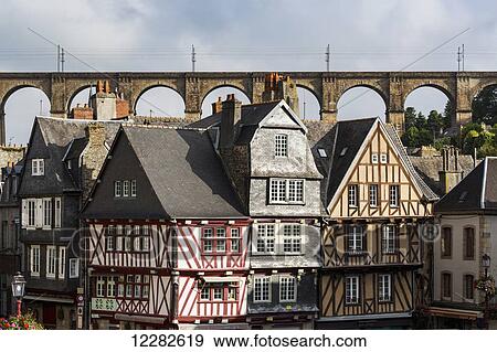 Half timbered old buildings with large stone viaduct in the background with blue sky and clouds; Morlaix, Brittany, France View Large Photo Image Stock Photo - Half timbered old buildings with large stone viaduct in the background with blue sky and clouds; Morlaix, Brittany, France. Fotosearch
