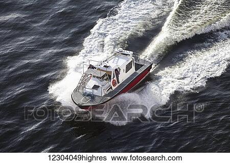 Stock Photograph - High angle view of a motorboat traveling in the water; Rio de Janeiro, Brazil. Fotosearch