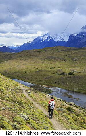 Stock Photograph - Hiker in Torres del Paine National Park in Chilean Patagonia; Magallanes, Chile. Fotosearch