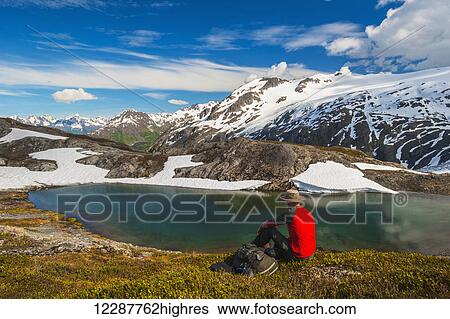 Hiker rests alongside a lake while hiking the Harding Icefield Trail, Kenai Fjords National Park, Kenai Peninsula, Southcentral Alaska View Large Photo Image Stock Photograph - Hiker rests alongside a lake while hiking the Harding Icefield Trail, Kenai Fjords National Park, Kenai Peninsula, Southcentral Alaska. Fotosearch