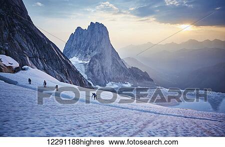 Hiking around a crevice of West Ridge of Pigeon Spire route in the Bugaboos Provincial Park at dawn; British Columbia, Canada View Large Photo Image Stock Photograph - Hiking around a crevice of West Ridge of Pigeon Spire route in the Bugaboos Provincial Park at dawn; British Columbia, Canada. Fotosearch