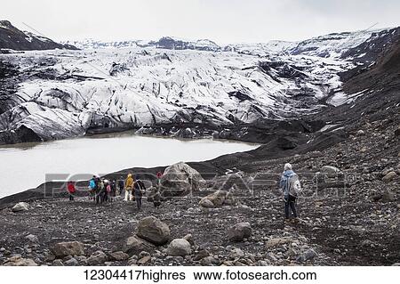 Stock Photograph - Hiking through the Solheimajokull glacier; Solheimajokull, Iceland. Fotosearch