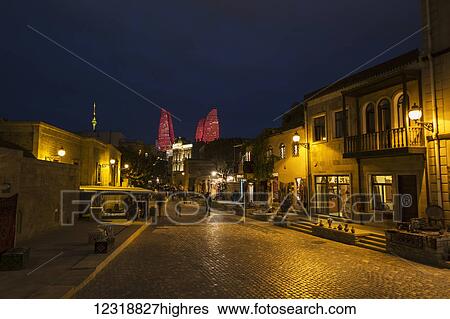 Stock Photograph - Houses and shops on Boyuk Qala Street at night; Baku, Azerbaijan. Fotosearch