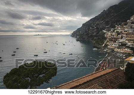 Houses on the hillside and boats in the water along the Amalfi coast; Positano, Campania, Italy View Large Photo Image Stock Photograph - Houses on the hillside and boats in the water along the Amalfi coast; Positano, Campania, Italy. Fotosearch
