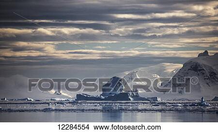 Iceberg in Gerlache Strait in front of glaciated peaks on Antarctic Peninsula; Antarctica View Large Photo Image Picture - Iceberg in Gerlache Strait in front of glaciated peaks on Antarctic Peninsula; Antarctica. Fotosearch