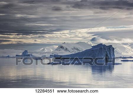 Iceberg in Gerlache Strait in front of glaciated peaks on Antarctic Peninsula; Antarctica View Large Photo Image Stock Image - Iceberg in Gerlache Strait in front of glaciated peaks on Antarctic Peninsula; Antarctica. Fotosearch