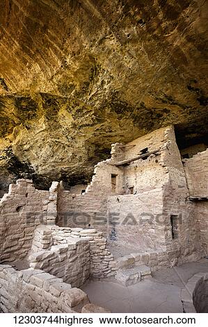Stock Photograph - Inside the Spruce Tree House cliff dwellings at Mesa Verde National Park with ancient ruins under a sweeping rock overhang; Colorado, United States of America. Fotosearch