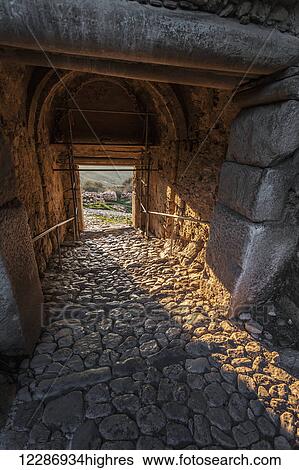 Interior of a building with arched roof, stone beams and cobblestone ground; Corinth, Greece View Large Photo Image Stock Photograph - Interior of a building with arched roof, stone beams and cobblestone ground; Corinth, Greece. Fotosearch