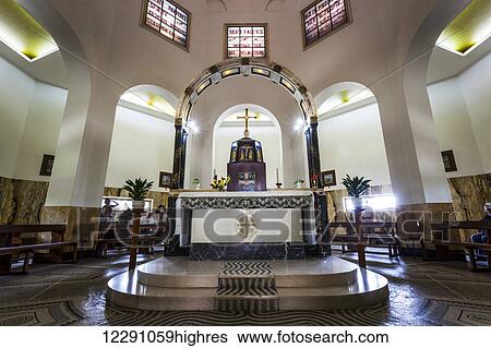 Stock Photograph - Interior of a church with stained glass windows and altar; Galilee, Israel. Fotosearch