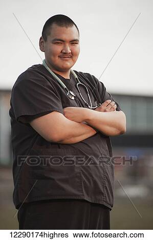 Inupiaq male doctor wearing a stethoscope & standing in front of the new native hospital in Barrow, North Slope, Arctic Alaska View Large Photo Image Stock Photograph - Inupiaq male doctor wearing a stethoscope & standing in front of the new native hospital in Barrow, North Slope, Arctic Alaska. Fotosearch