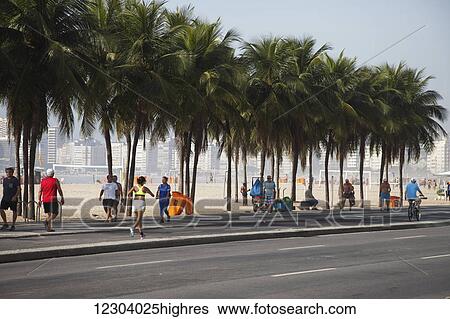 Stock Photograph - Jogging along Avenue Atlantica on Copacabana Beach; Rio de Janeiro, Brazil. Fotosearch