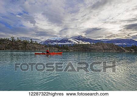 Stock Photograph - Kayaking on Atlin Lake; Atlin, British Columbia, Canada. Fotosearch