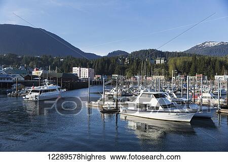 Stock Photograph - Ketchikan small boat harbor, downtown Ketchikan visible in the background, Ketchikan, Southeast Alaska, USA, Spring. Fotosearch