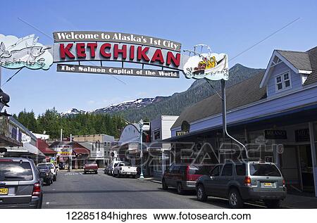 Stock Photograph - Ketchikan welcome sign hangs over Mission Street, Southeast Alaska, Summer. Fotosearch