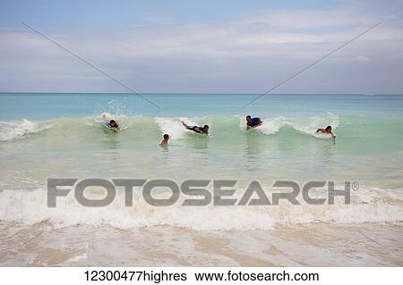 Kids boogie boarding at Waimanalo Beach; Oahu, Hawaii, United States of America View Large Photo Image Stock Photograph - Kids boogie boarding at Waimanalo Beach; Oahu, Hawaii, United States of America. Fotosearch