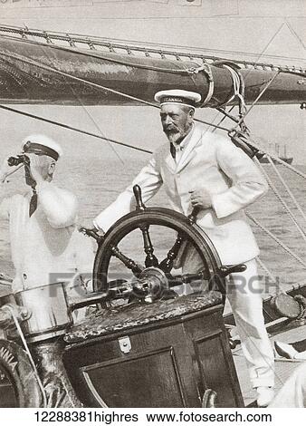 Stock Photograph - King George V at the wheel of his yacht, Britannia, during Cowes Regatta Week, England, 1924. From The Story of 25 Eventful Years in Pictures, published 1935.. Fotosearch